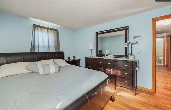 a bed sitting in a bedroom next to a window