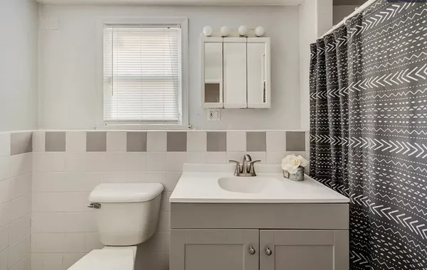 a swimming pool with lawn chairs and wooden fence