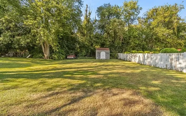 a swimming pool with trees in the background