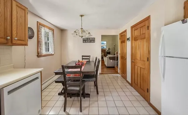 a kitchen with stainless steel appliances a refrigerator and a table