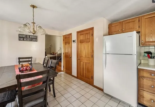 a living room with stainless steel appliances granite countertop furniture rug and wooden floor