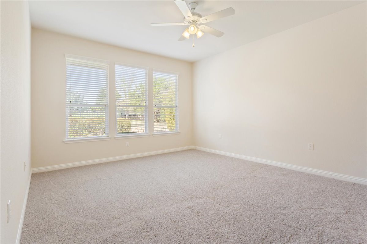 108 Cathedral Mountain Pass Georgetown, TX 78633 - Photo 18 of 36 an empty room with a window and a fan