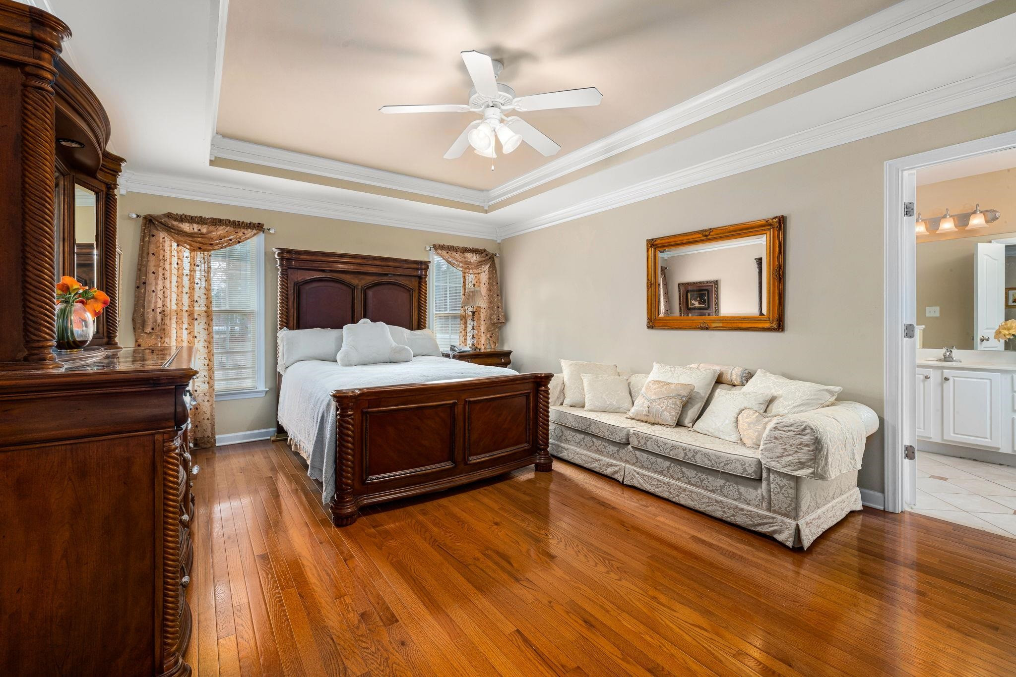 20 Crestline Drive Selma, NC 27576 - Photo 24 of 40 a spacious bedroom with a bed a couch and a chandelier