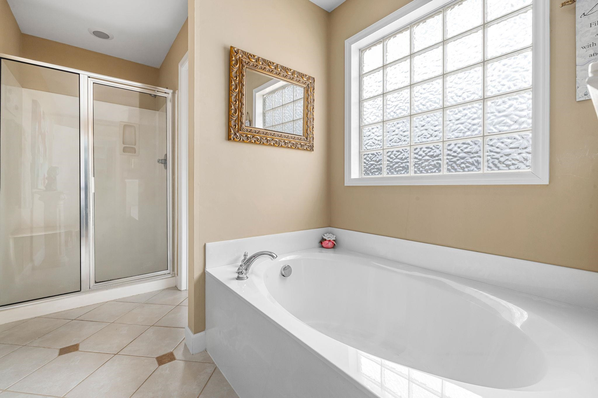 20 Crestline Drive Selma, NC 27576 - Photo 28 of 40 a white bath tub sitting in a bathroom next to a window
