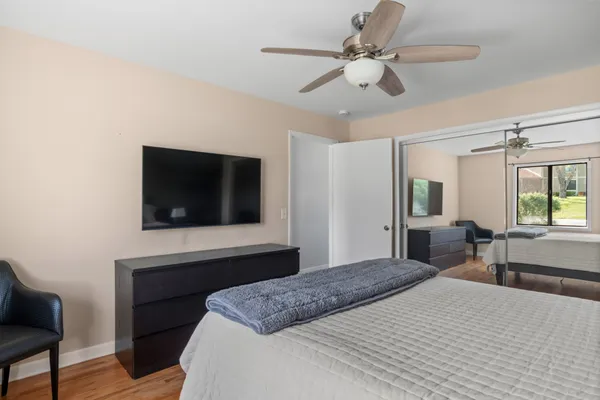 a bedroom with a bed and a flat screen tv