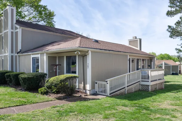 a view of a house with a yard and furniture