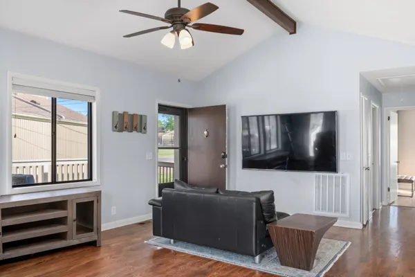 a living room with furniture and a flat screen tv