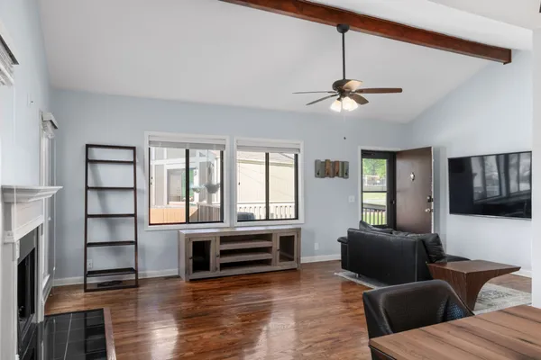 a living room with furniture fireplace and flat screen tv