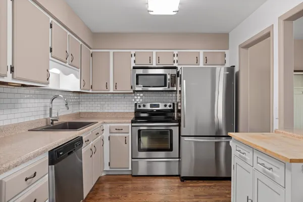 a kitchen with a sink stove and refrigerator