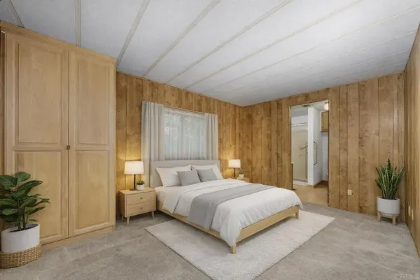 a bedroom with a bed and a potted plant