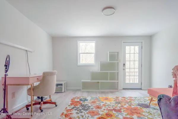 a bedroom with furniture and a window