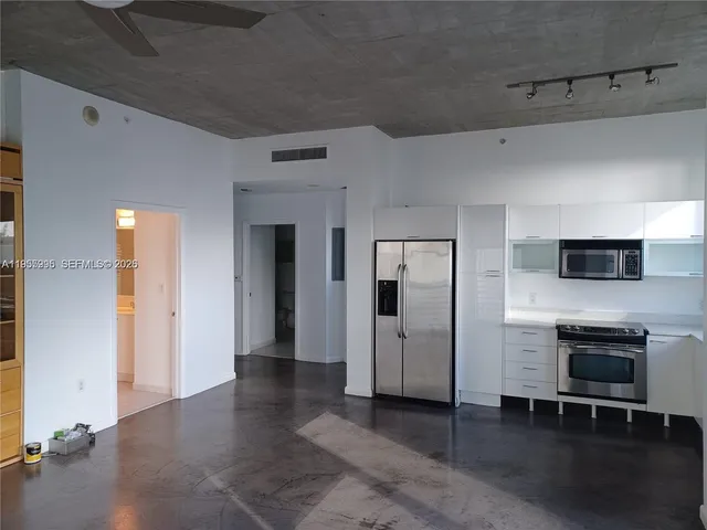 a kitchen with stainless steel appliances a stove a sink and a refrigerator