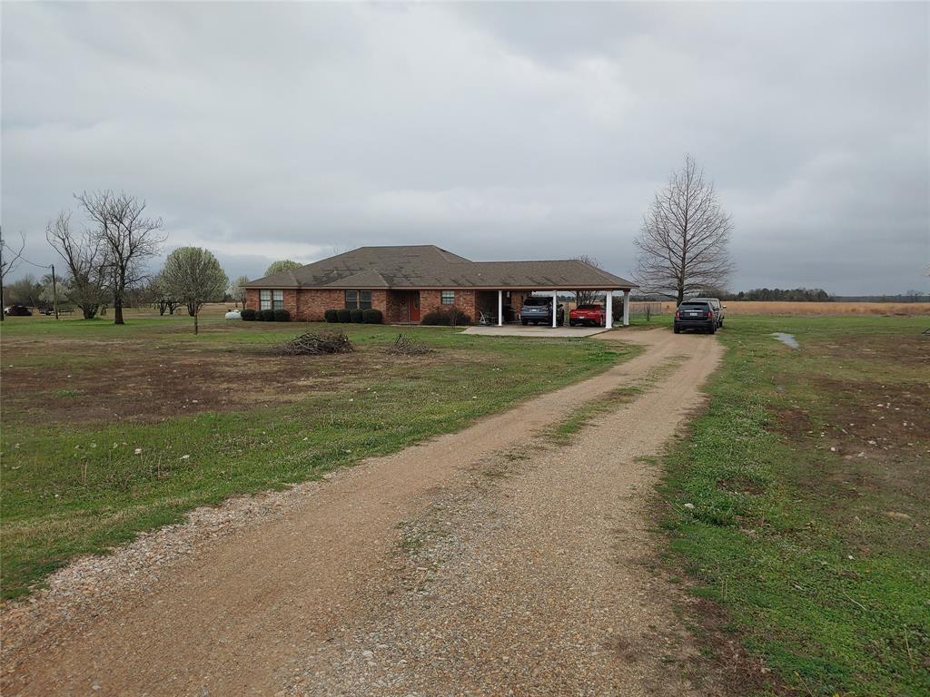 84 County Road Sumner, TX 75486 - Photo 1 of 33 a front view of a house with a yard and garage