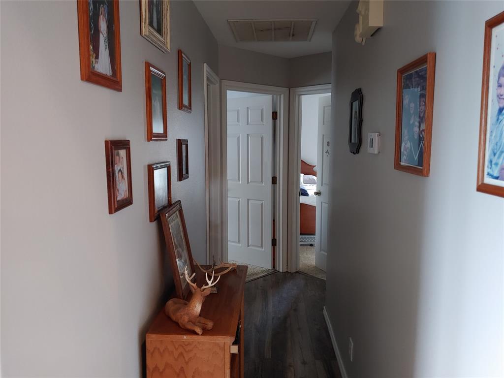 84 County Road Sumner, TX 75486 - Photo 12 of 33 Hallway featuring dark wood finished floors and baseboards