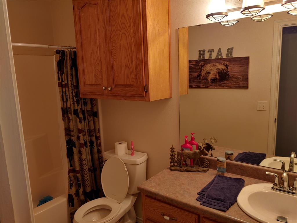 84 County Road Sumner, TX 75486 - Photo 14 of 33 a bathroom with a sink mirror and toilet