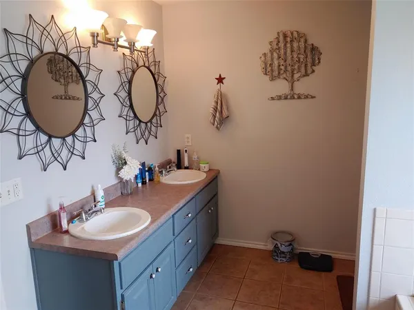 a bathroom with a tub sink and a window