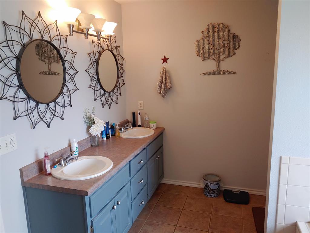 84 County Road Sumner, TX 75486 - Photo 22 of 33 a bathroom with a sink and a mirror