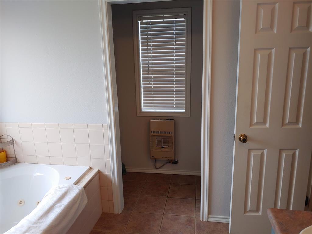 84 County Road Sumner, TX 75486 - Photo 23 of 33 a bathroom with a tub sink and a window
