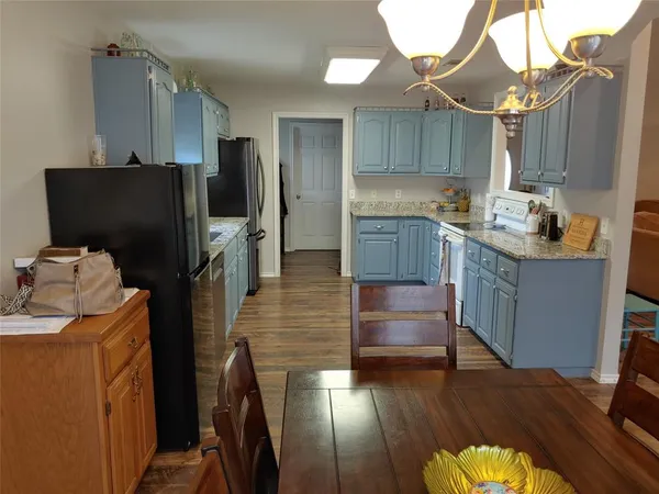 a kitchen with kitchen island wooden cabinets and stainless steel appliances