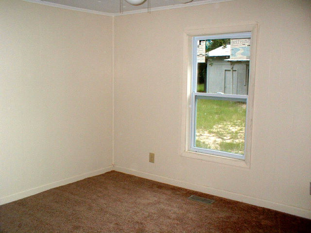 1122 Barn Owl Road Aiken, SC 29805 - Photo 16 of 18 an empty room with a window and wooden floor