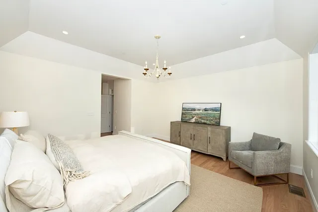 a spacious bedroom with a bed and a couch