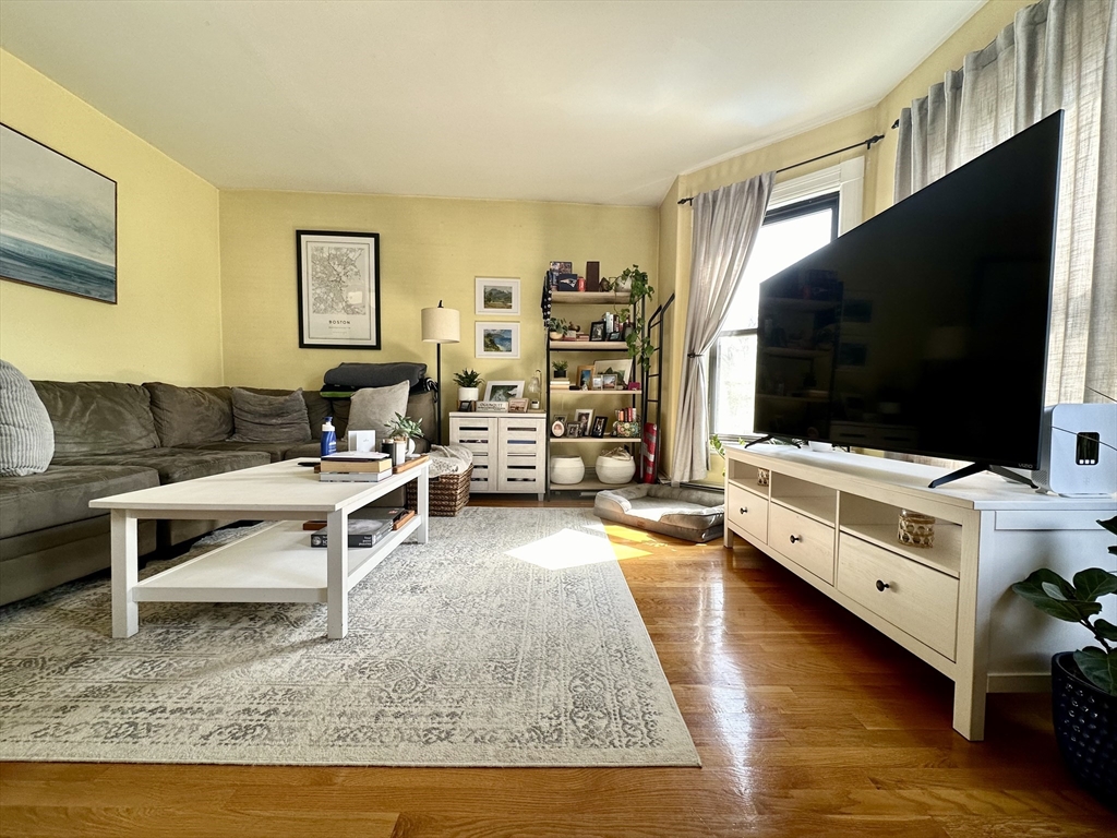 9 Leverett Street, Unit 3 Brookline, MA 02445 - Photo 1 of 8 a living room with furniture and a flat screen tv
