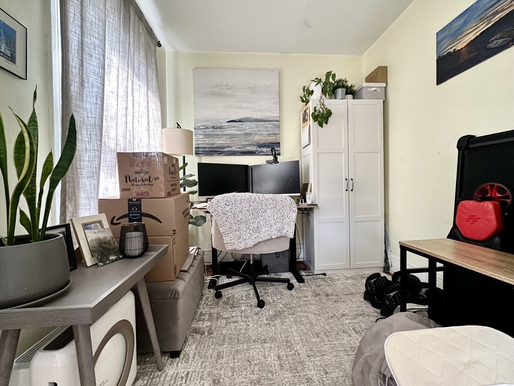 9 Leverett Street, Unit 3 Brookline, MA 02445 - Photo 3 of 8 a view of a workspace with furniture and a potted plant