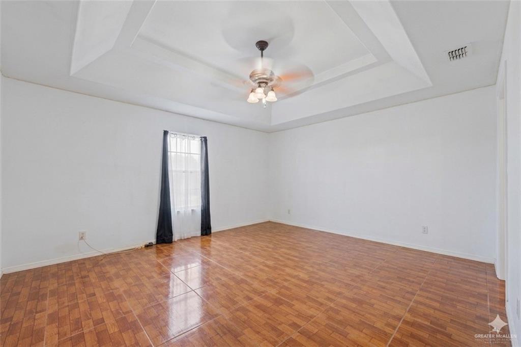 24175 Engleman Road Edcouch, TX 78538 - Photo 18 of 22 a view of an empty room with chandelier fan and a window