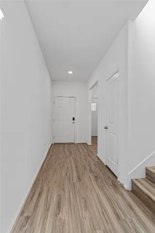 a view of a room with wooden floor