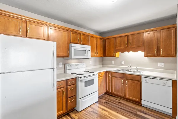 a kitchen with a white cabinets and white appliances
