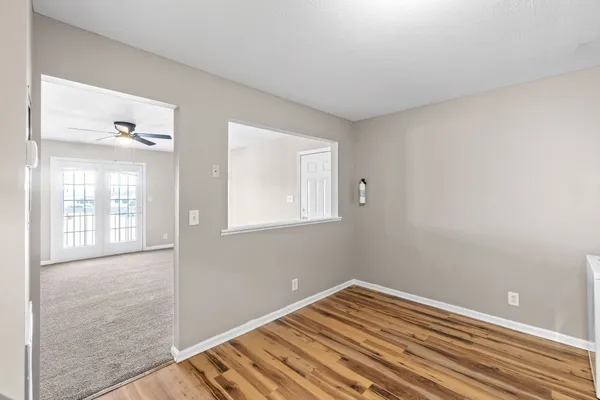 a view of a room with wooden floor and windows