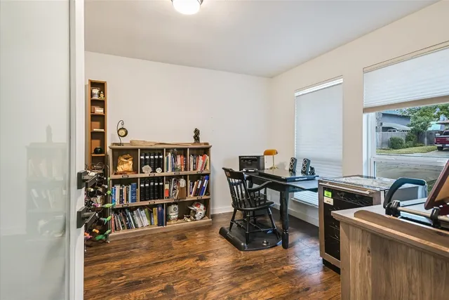 a view of a workspace with furniture and a bookshelf