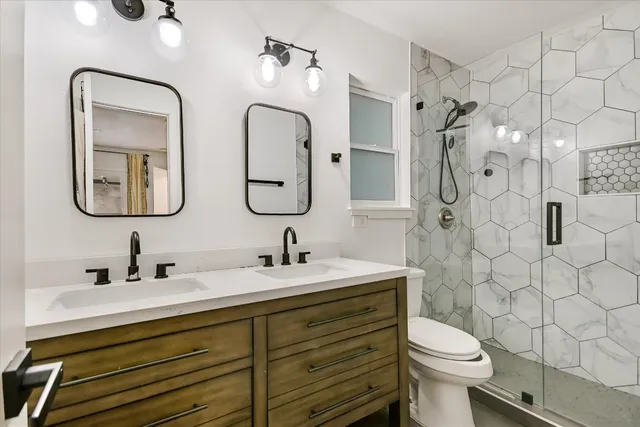 a bathroom with a toilet sink and mirror