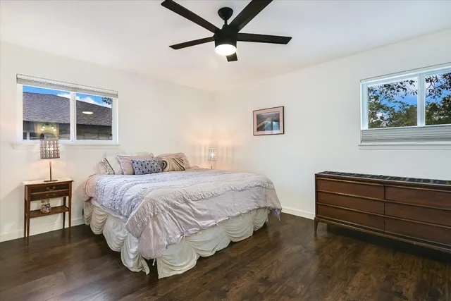 a bedroom with a bed and a painting on the wall