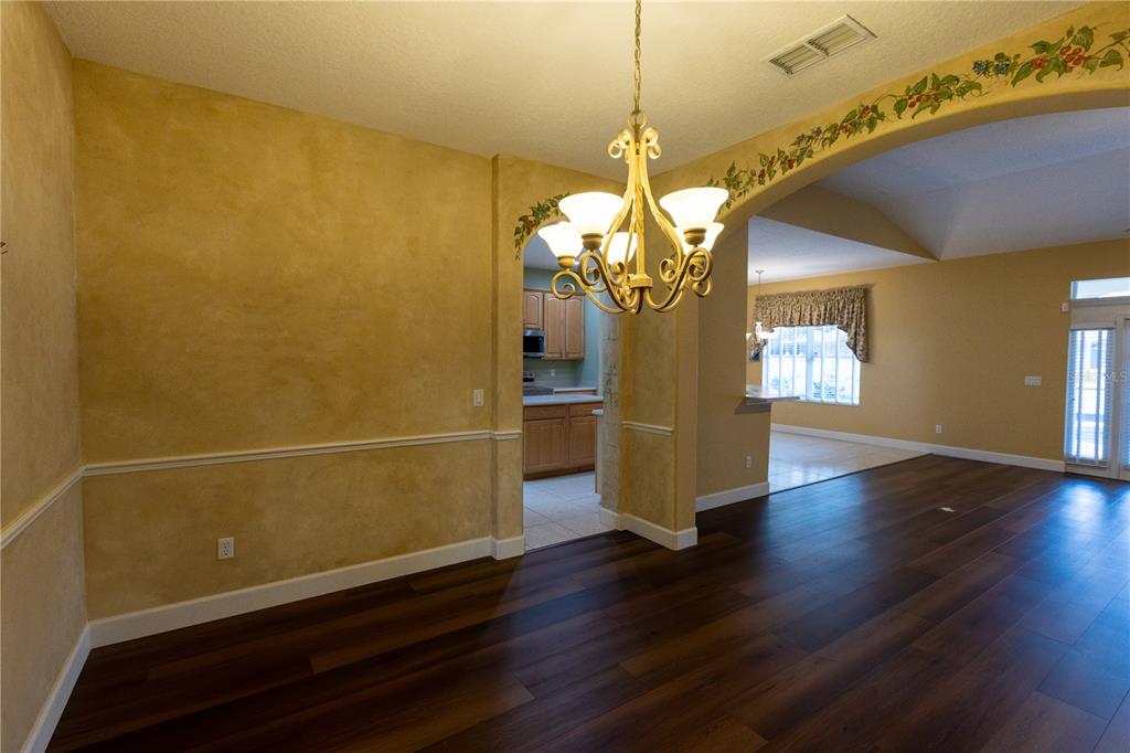 65 Calliope Street Ocoee, FL 34761 - Photo 11 of 60 a view of a room with wooden floor staircase and a kitchen