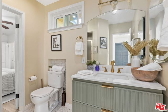 a bathroom with a toilet sink and mirror