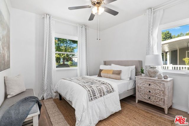 a bedroom with a bed dresser and a window