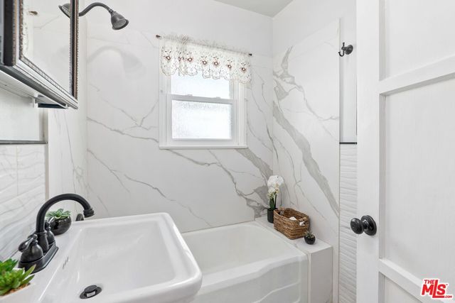 a bathroom with a sink and a window