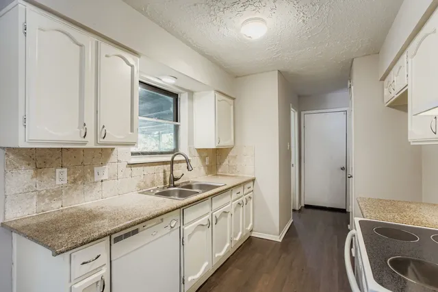 a kitchen with stainless steel appliances granite countertop a sink stove and cabinets