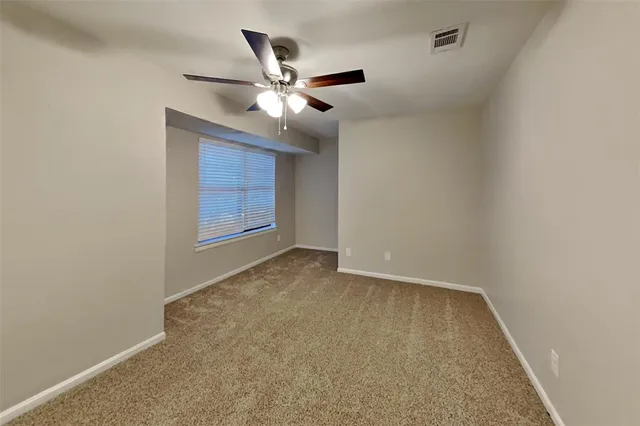 an empty room with closet and wooden floor