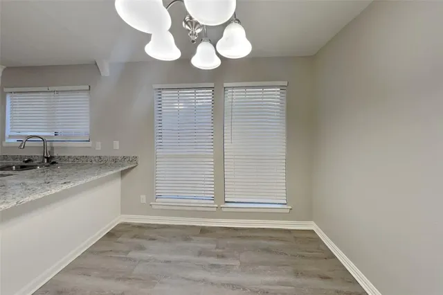 a view of a kitchen with a sink cabinets and wooden floor