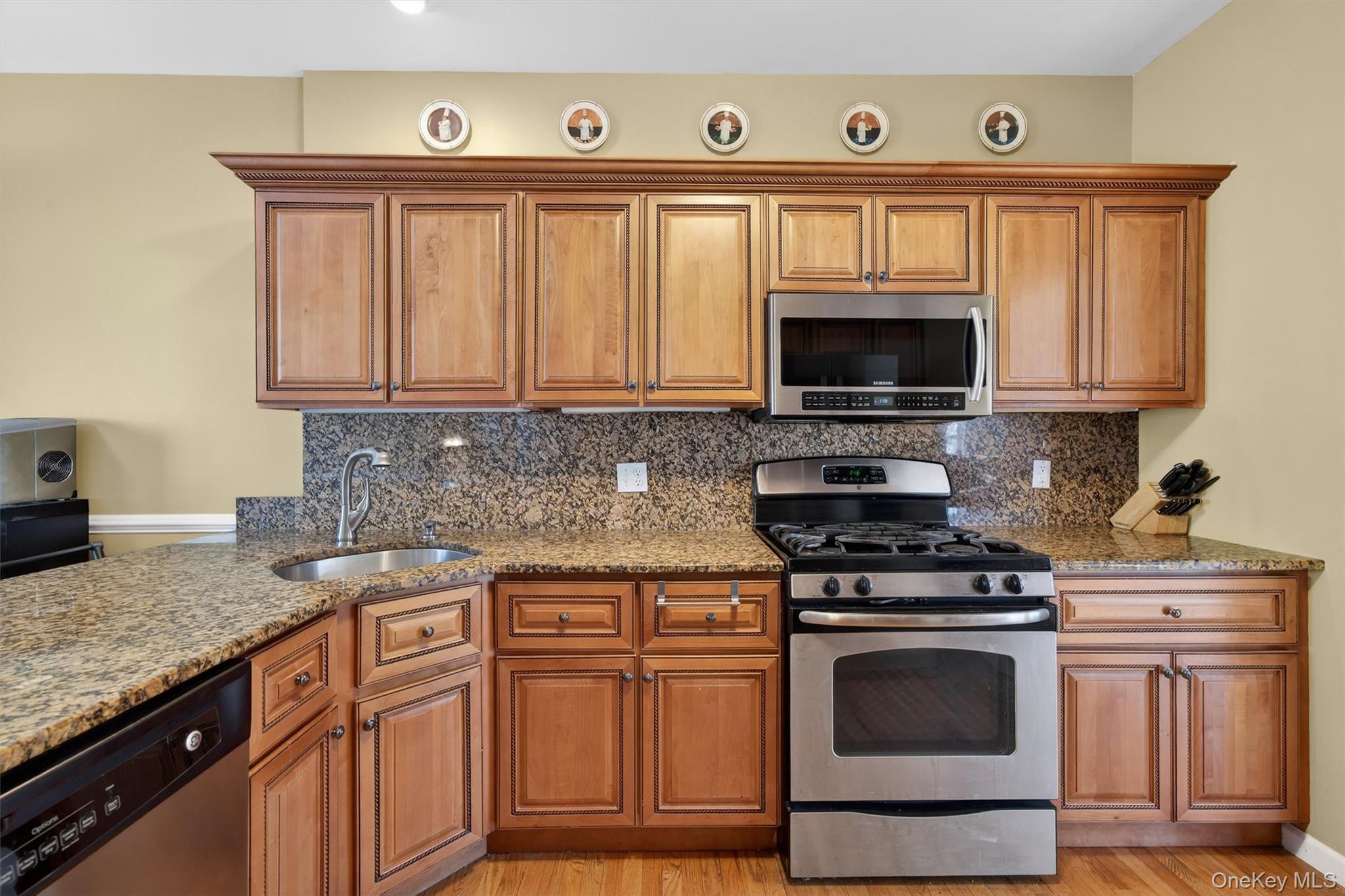 32 Peter Turner Road Monroe, NY 10950 - Photo 17 of 42 a kitchen with granite countertop a stove top oven microwave and cabinets