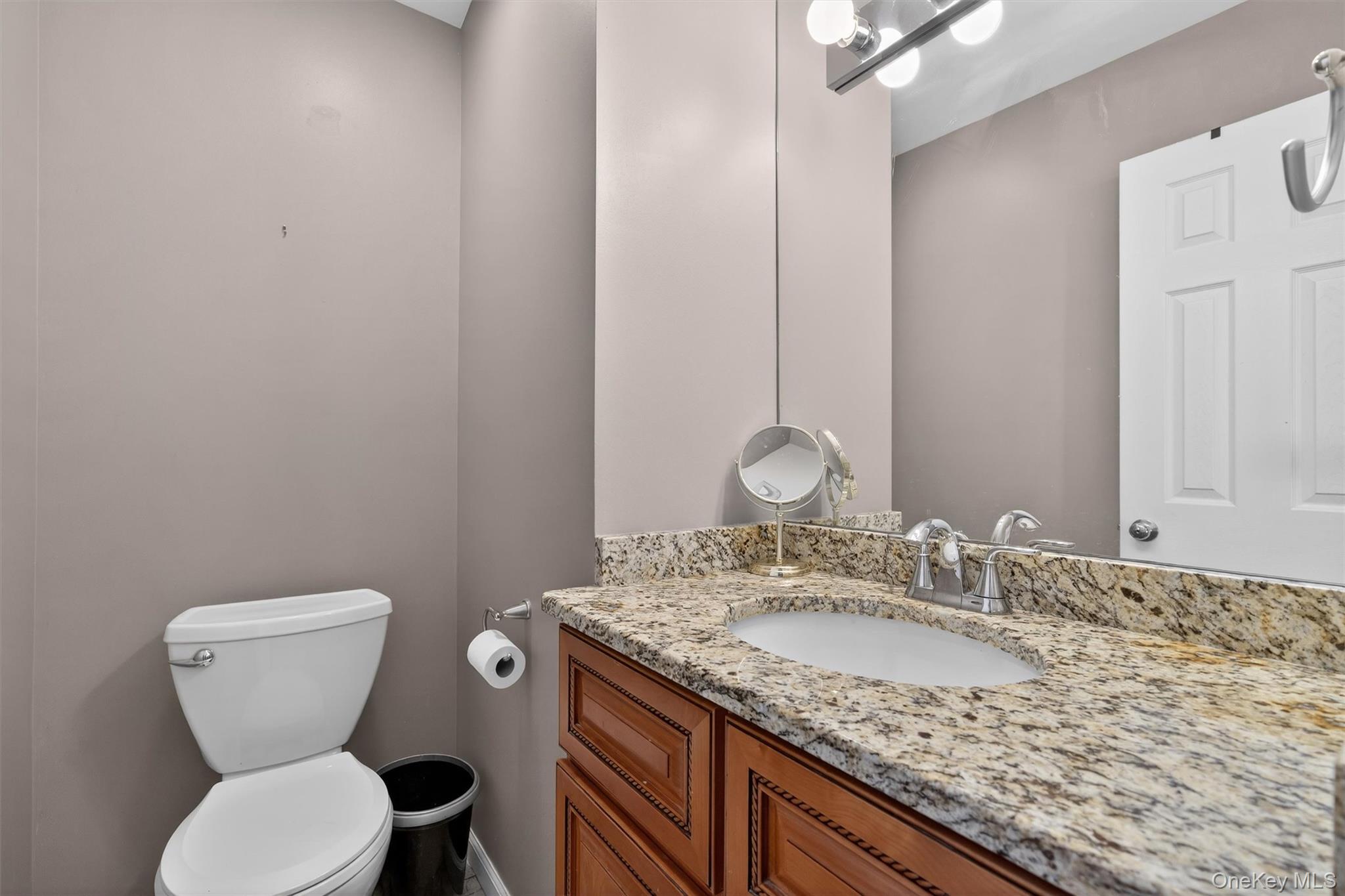 32 Peter Turner Road Monroe, NY 10950 - Photo 27 of 42 a bathroom with a granite countertop toilet a sink and a mirror