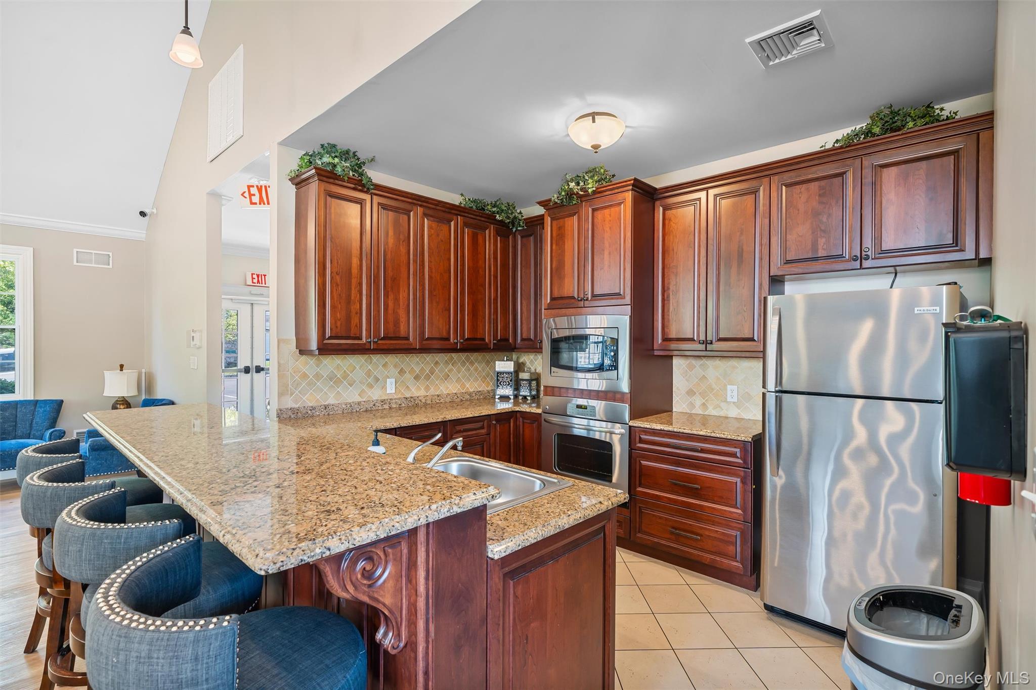 32 Peter Turner Road Monroe, NY 10950 - Photo 39 of 42 a kitchen with a refrigerator a stove and wooden cabinets