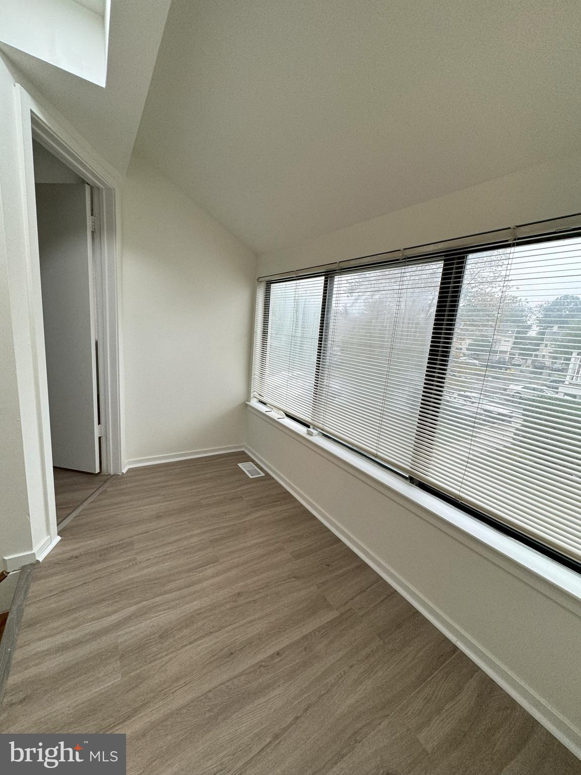 119 Sandra Road Voorhees, NJ 08043 - Photo 13 of 36 a view of an empty room with wooden floor and a window