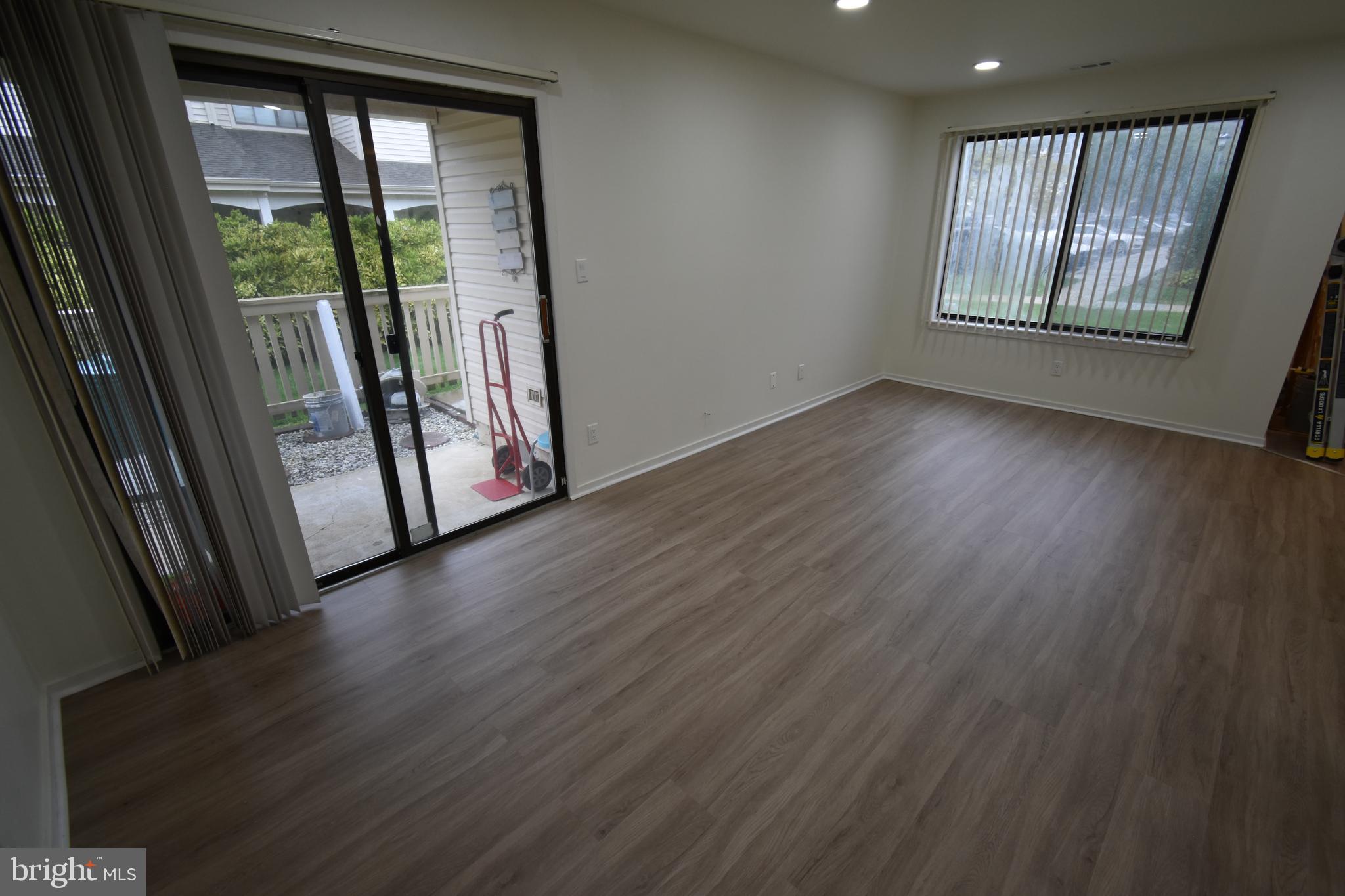 119 Sandra Road Voorhees, NJ 08043 - Photo 8 of 36 an empty room with wooden floor and windows