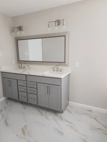 a bathroom with a sink a vanity and a mirror