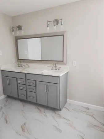 a bathroom with a sink a vanity and a mirror