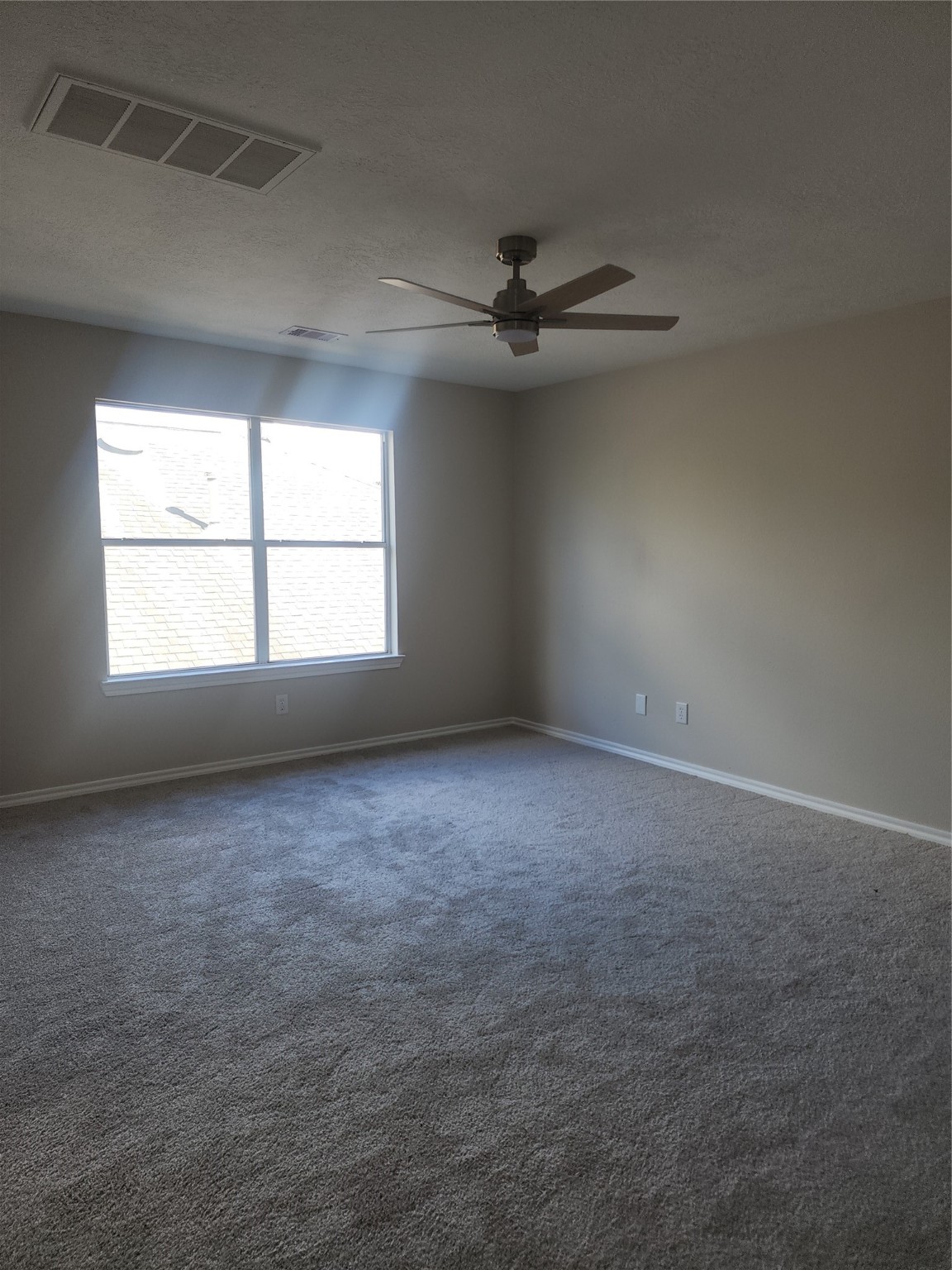 10614 Acacia Forest Trail Houston, TX 77089 - Photo 18 of 27 an empty room with a window and a fan