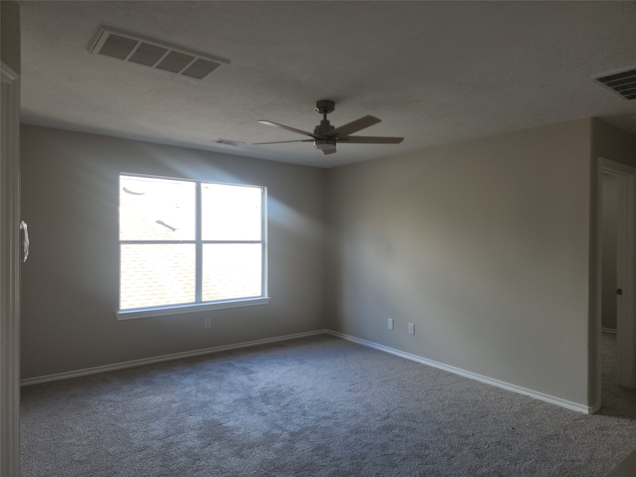 10614 Acacia Forest Trail Houston, TX 77089 - Photo 19 of 27 an empty room with a window and a ceiling fan